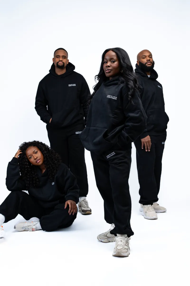 Group of four wearing all-black Create Your Greatness hoodies and sweatpants